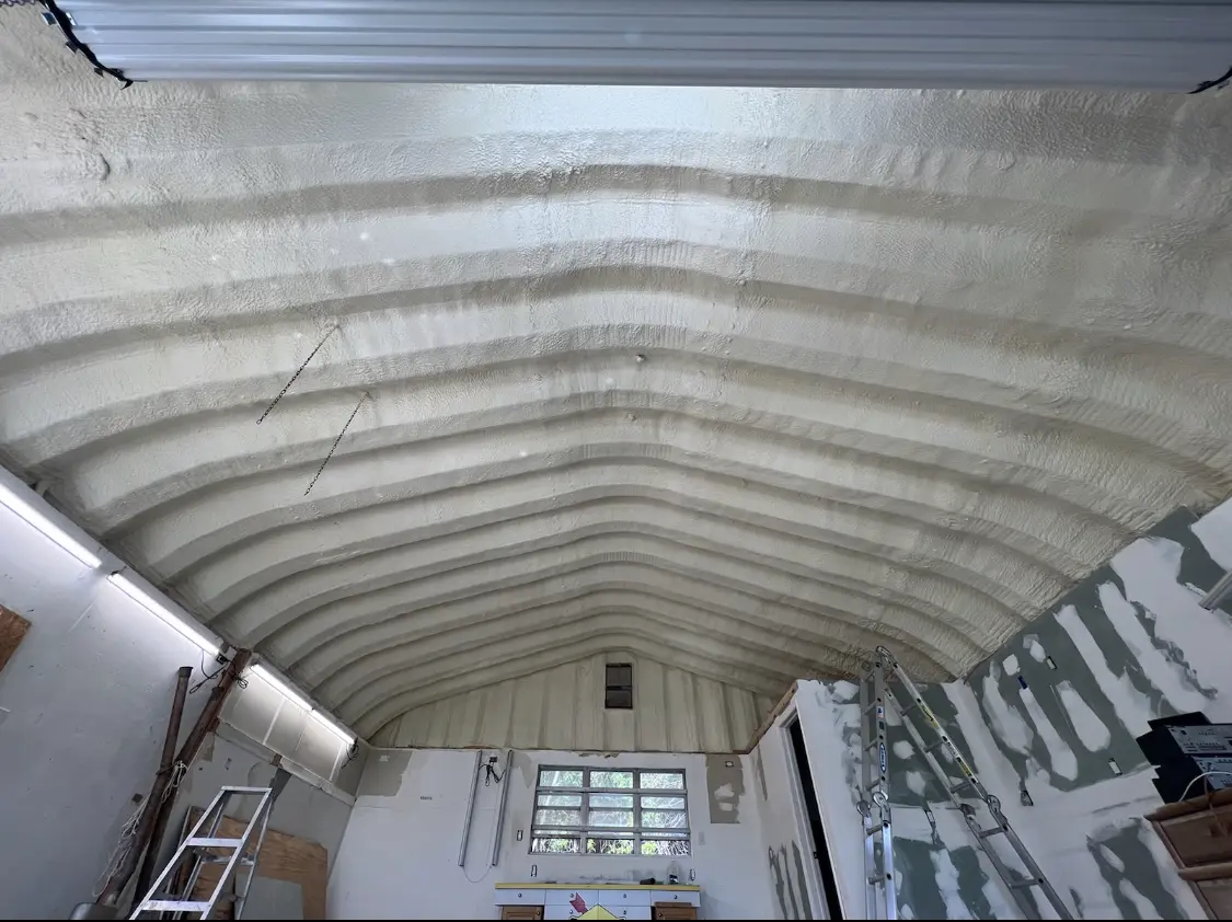 Spray polyurethane foam applied to the underside of a metal roof deck in Liberty